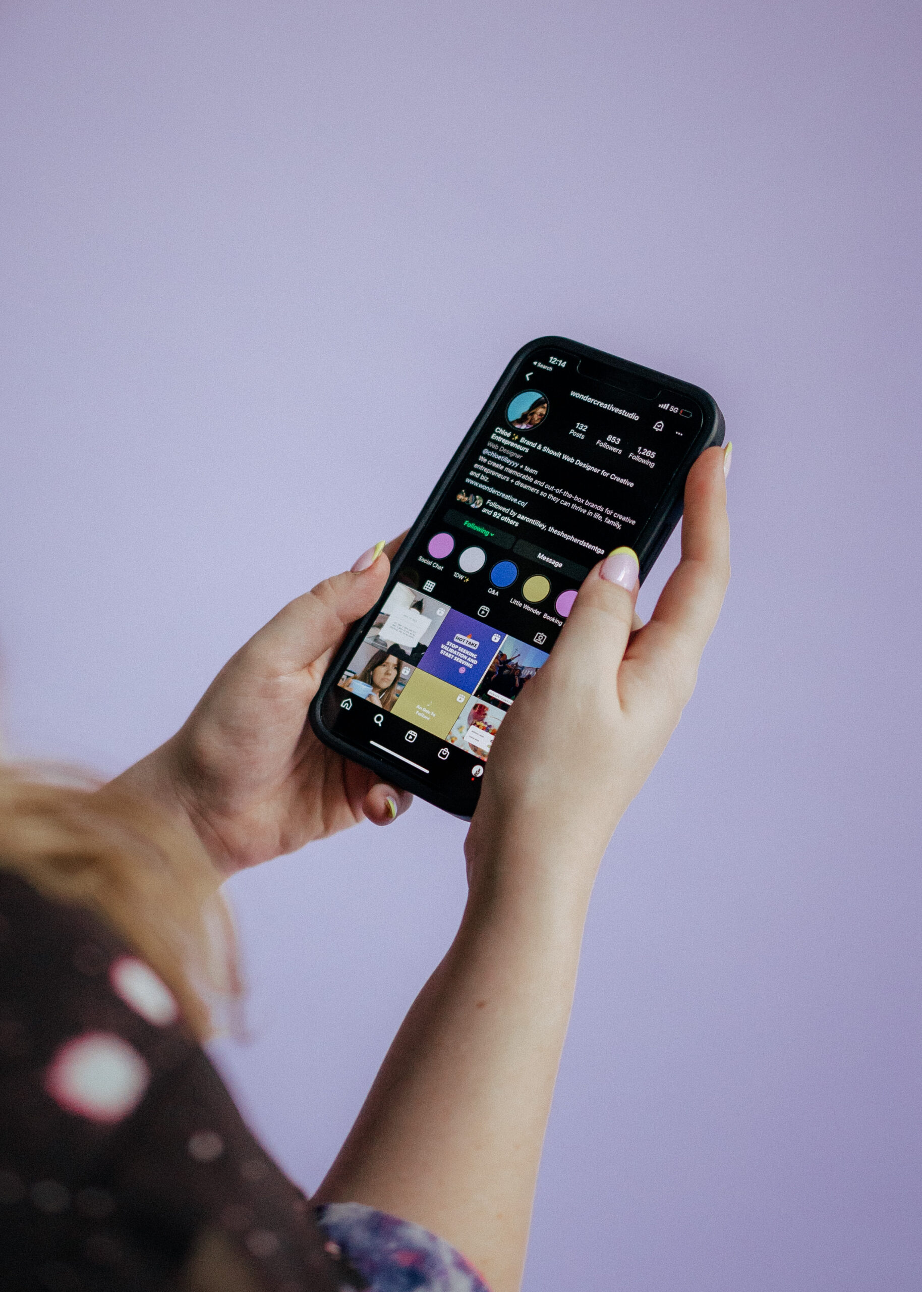 purple background with girl holding iphone with instagram account